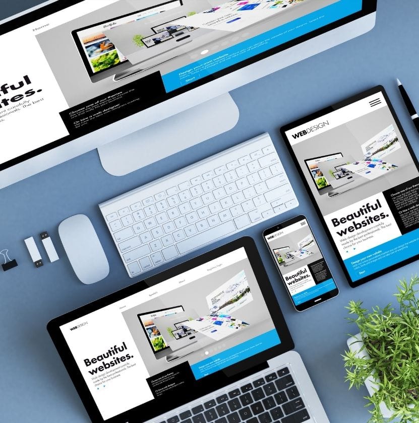 Top view of responsive website displayed on desktop, tablet, and smartphone with modern blue-white layout.